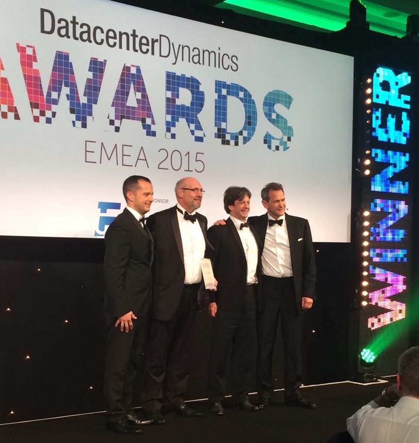 Ian Tasker (UIS) and Tony Collins (Cambridge Assessment), flanked by TV presenter Alexander Armstrong and a representative from CommScope, which sponsored the award category